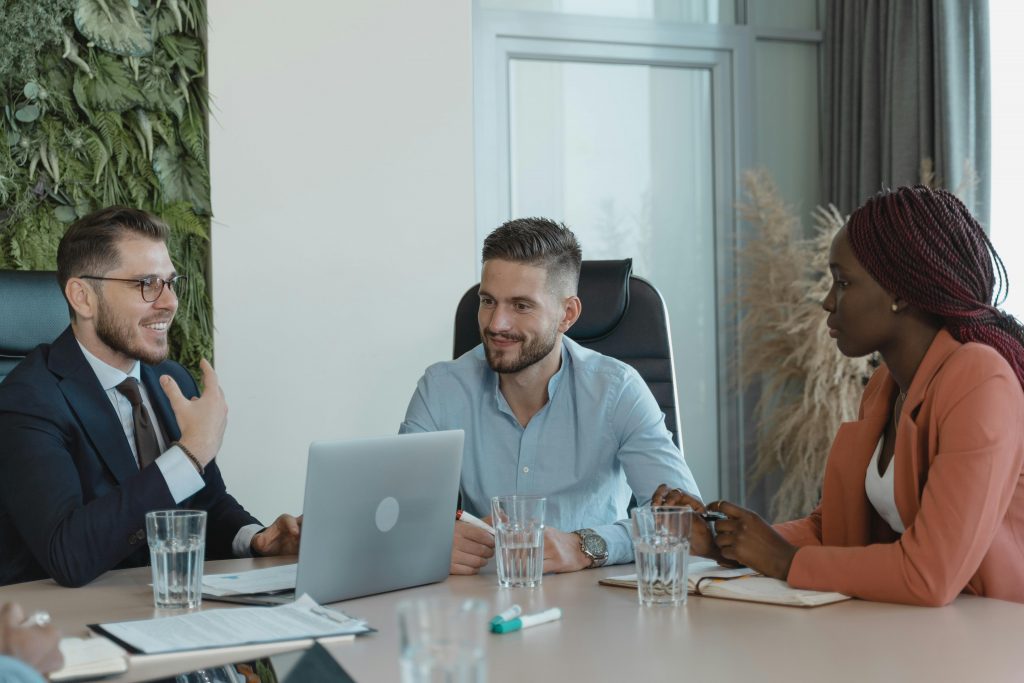 Diverse group of professionals engaging in a collaborative business meeting in an office space.